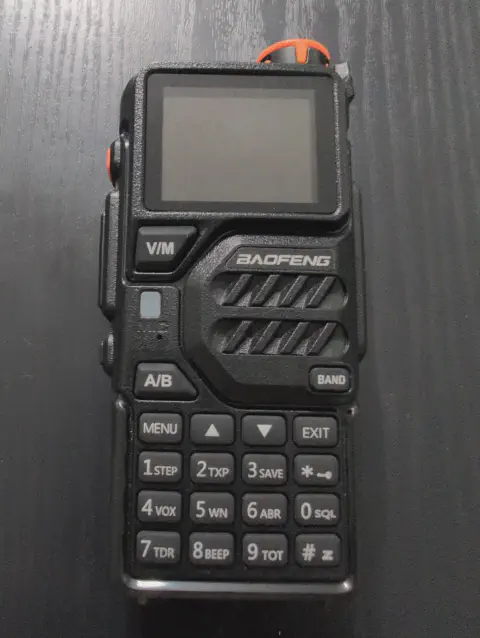 baofeng btech k5 plus front view without antenna black textured body single control knob lcd display numeric keypad control buttons speaker grille