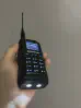 Thumbnail of baofeng btech uv 17r plus front bottom view showing two led flashlight turned on black textured body