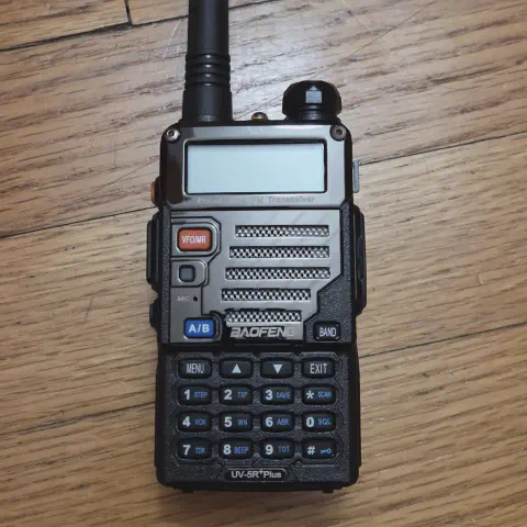 baofeng btech uv 5r plus front view with black antenna attached metalic smooth and black textured body single control knob lcd display numeric keypad function keys