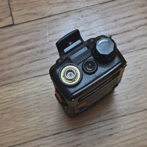 baofeng btech uv 5r plus top view showing sma m connector without antenna black textured body single control knob led flashlight