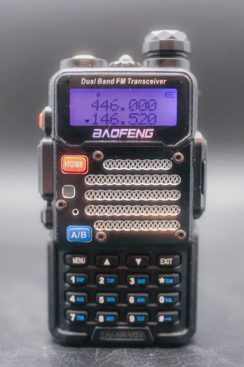 baofeng btech uv 5r v2 front view without antenna black textured body single control knob lcd display numeric keypad speaker grille