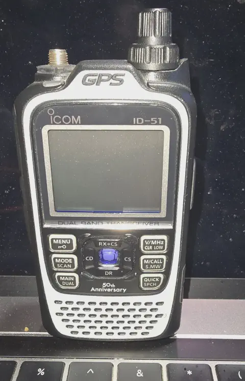 icom id 51 front view showing sma f connector without antenna black textured body single stacked control knob lcd display control buttons smooth white faceplate around screen buttons and speaker grille