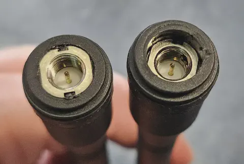 two black antennas with sma m connector side by side one with deeper recessed connector