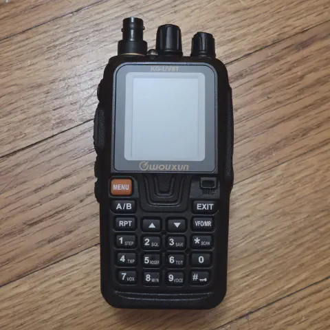 wouxun kg uv8t front view with black bnc adapter attached black textured body two control knobs led flashlight lcd display numeric keypad function keys