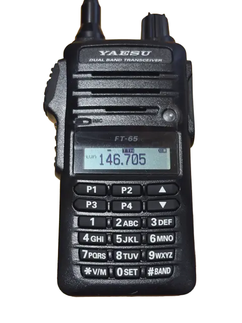 yaesu ft 65 front view with black aftermarket antenna black textured body two control knobs lcd display numeric keypad function keys speaker grille